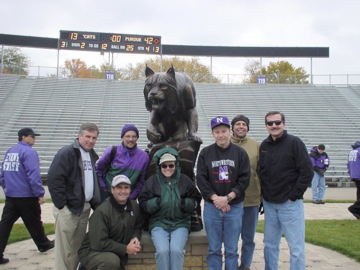 Tim Collins '83, Paul Fuligni, Paul Driscoll, Chris Sopata, Roy Meyer, Kaveh Safavi, Dave Fischer '81 gathered around the wildcat statue at the south end of Ryan Field on 10/26/2002